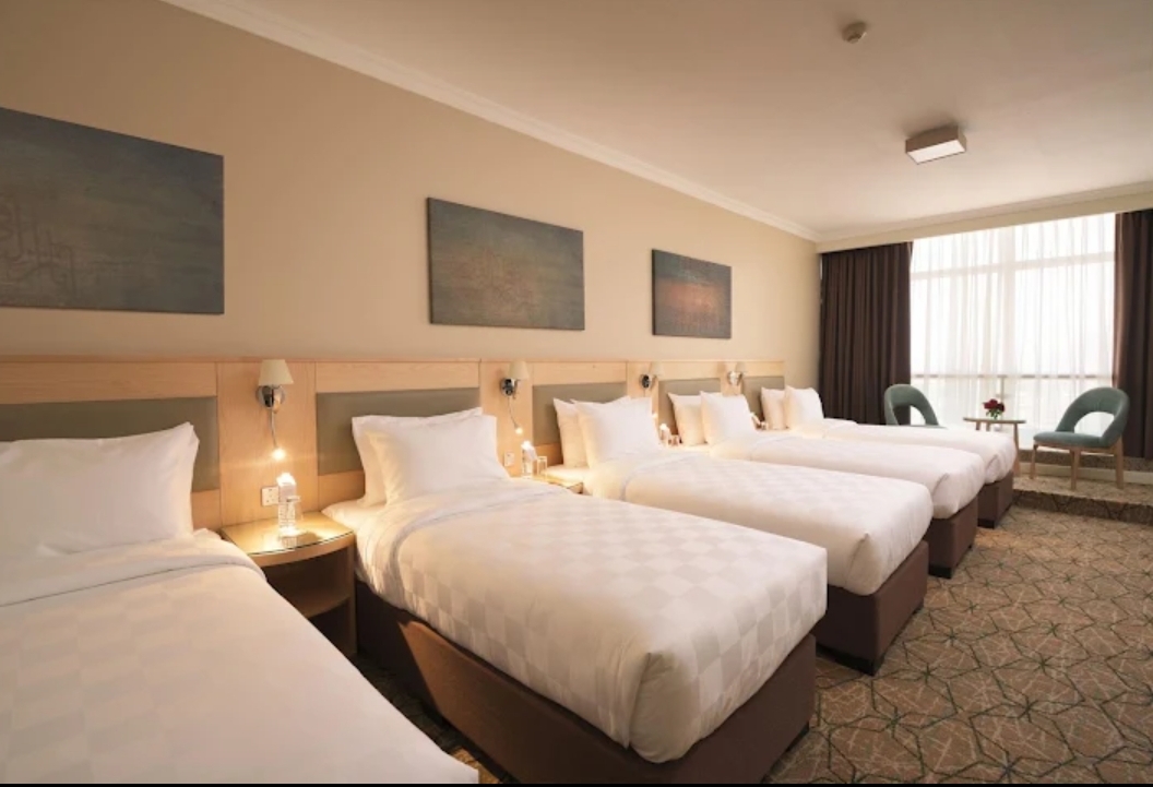 Quad room with four single beds in a 4 star hotel