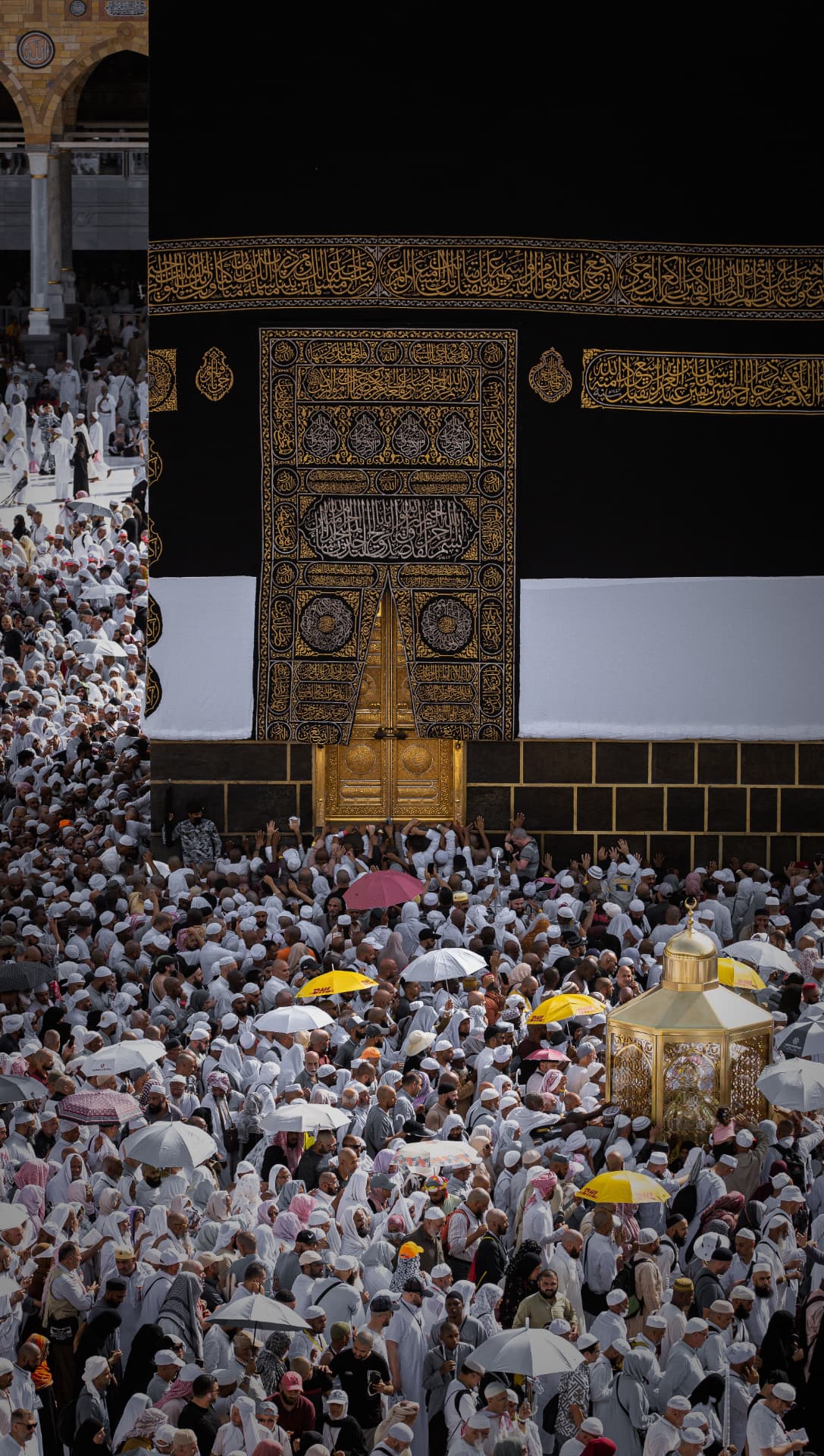 Pilgrims gathered before the golden door of the Ka'bah during tawaf