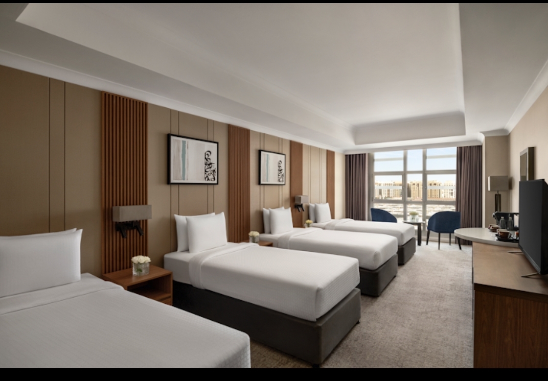 Modern 5 star family room with four beds and a window view