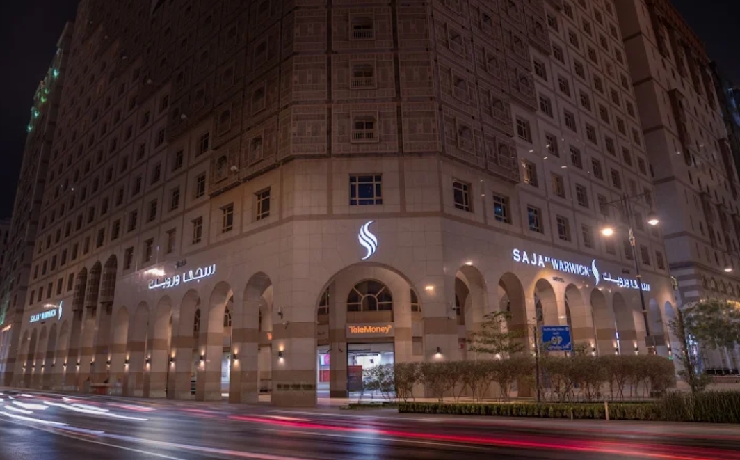Saja Al Madinah hotel lit up at night
