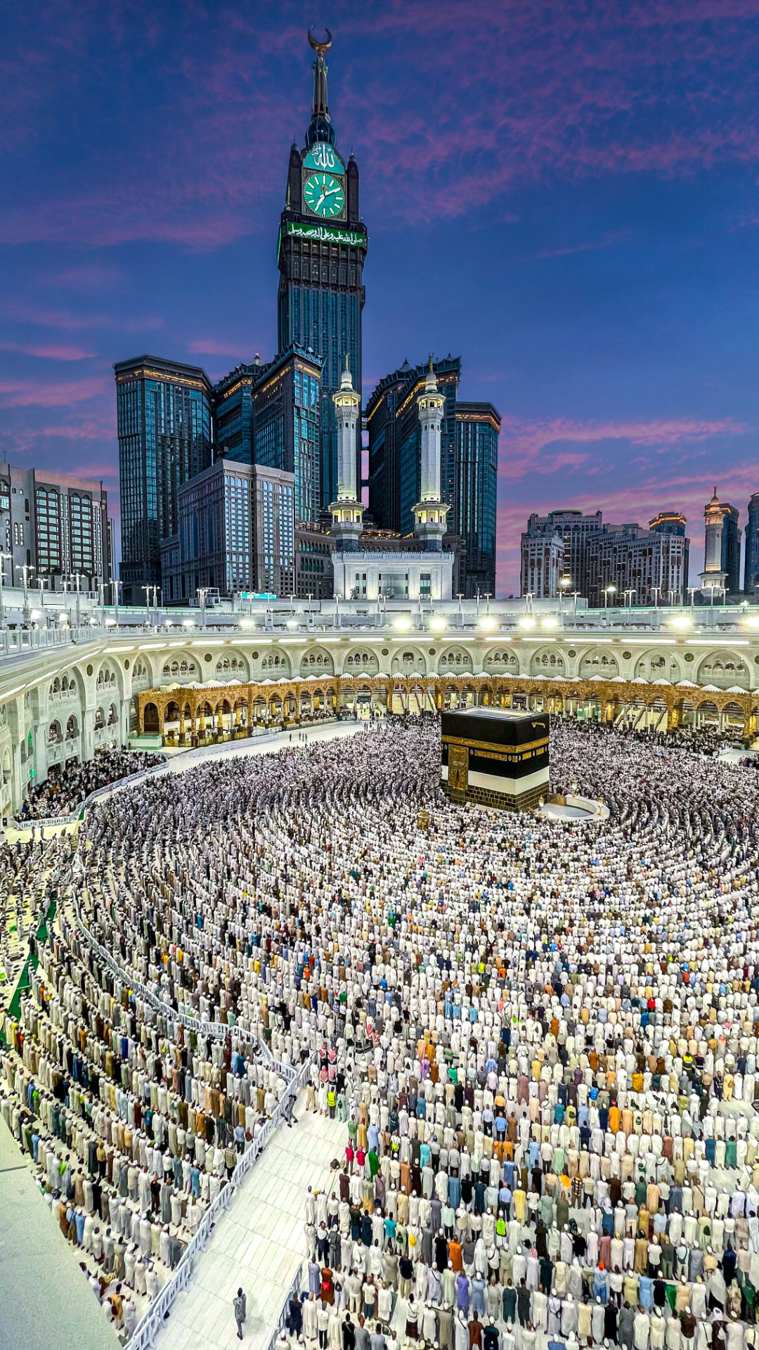 Masjid al-Haram at dusk with the Ka'bah and the Makkah Clock Tower above the courtyard