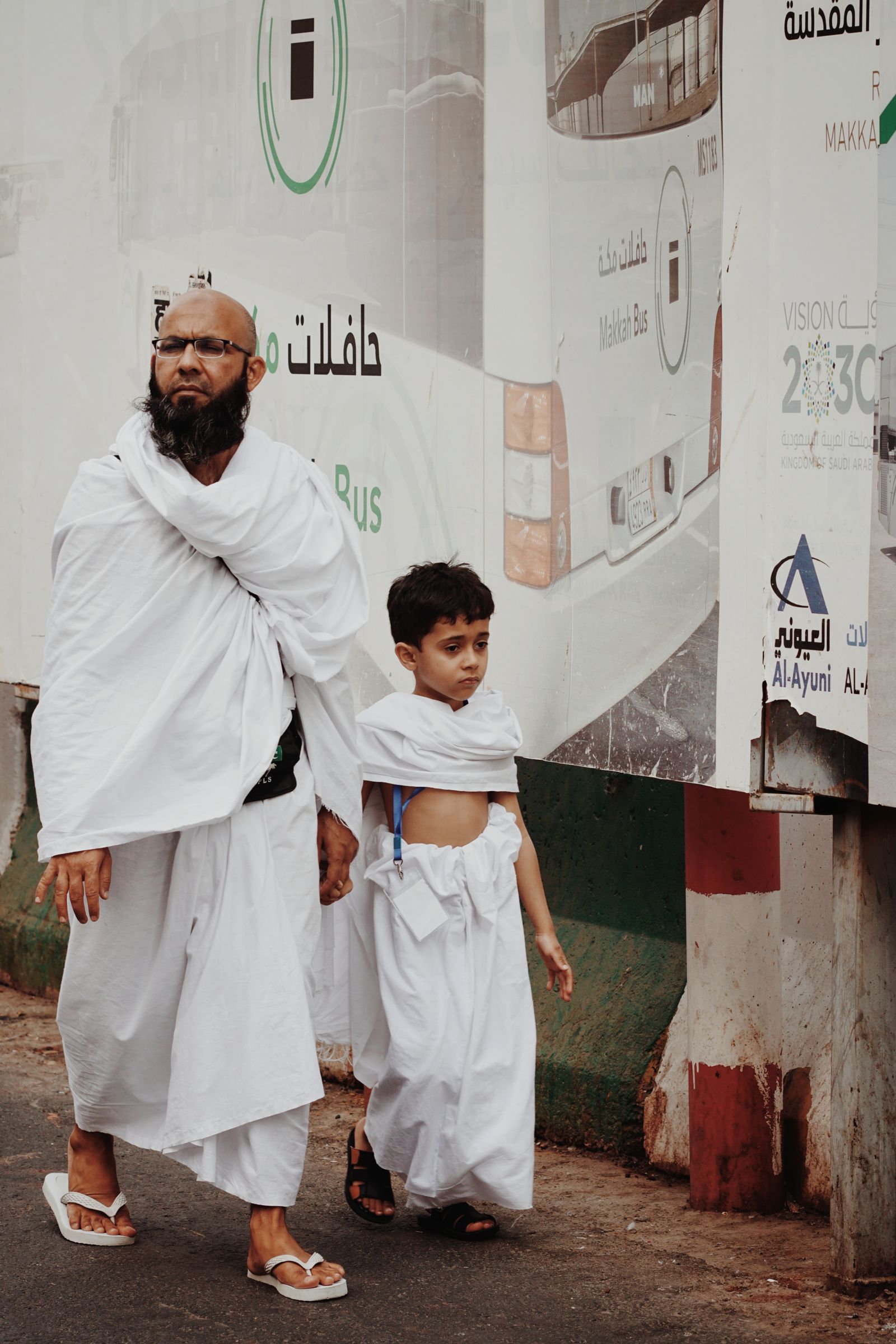 Pilgrims wearing the two white sheets of ihram before setting out for Umrah