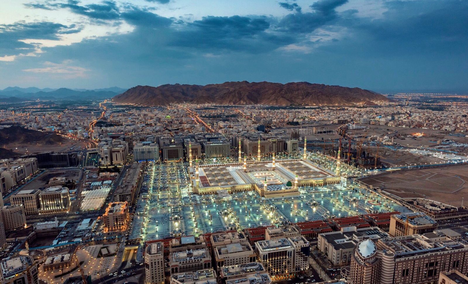 Aerial view of Masjid an-Nabawi in Madinah illuminated at dusk